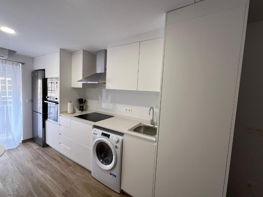 a white kitchen with a washing machine in it at White House in Castellón de la Plana