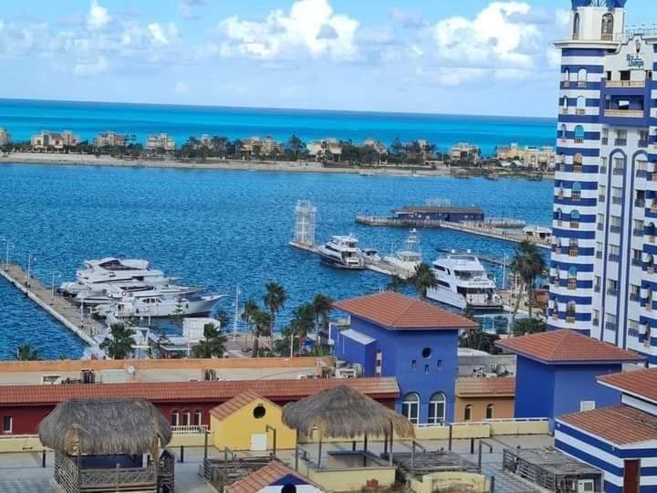 a view of a harbor with boats in the water at Porto marina in El Alamein