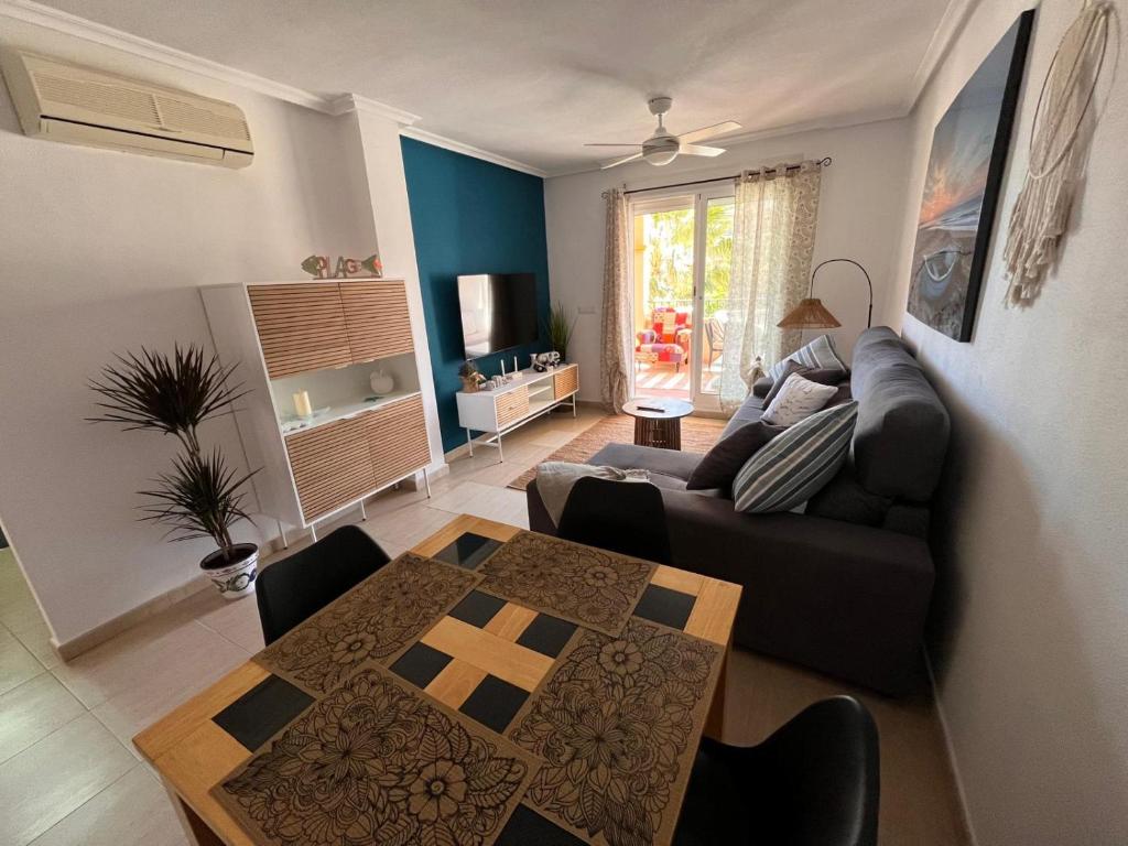a living room with a couch and a table at Estrella in Mar de Cristal