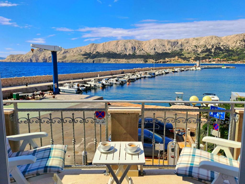 a balcony with a view of a marina at Apartment & studio Elizabet in Baška