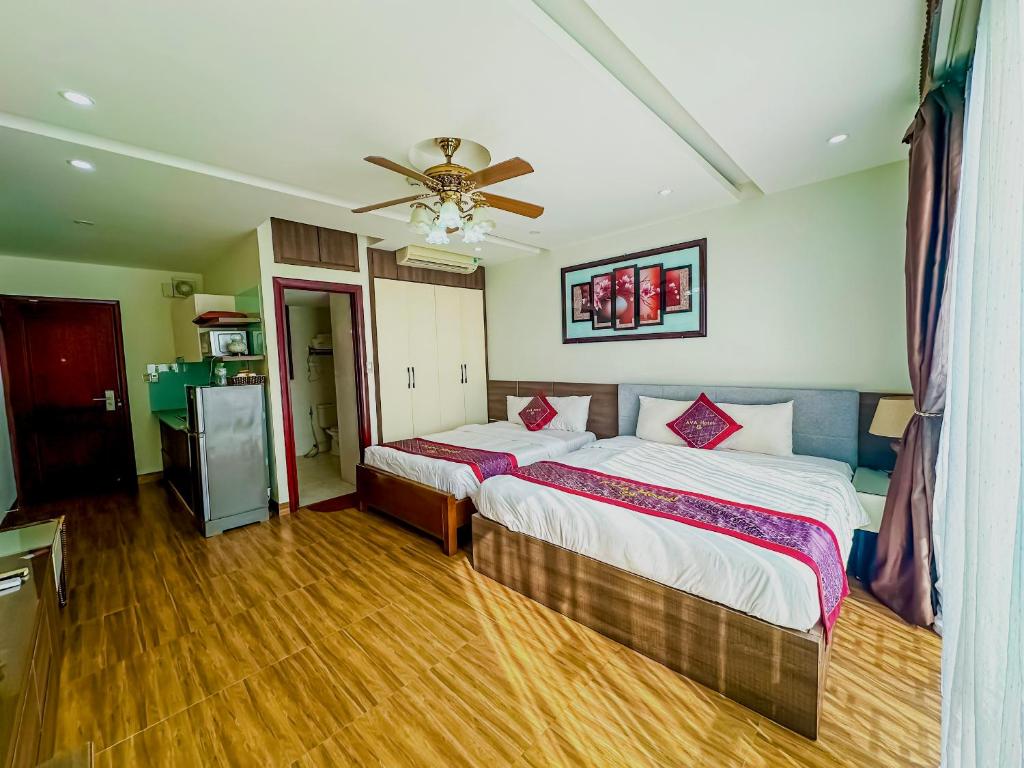 a bedroom with two beds and a ceiling fan at AVA Hotel & Apartment in Da Nang