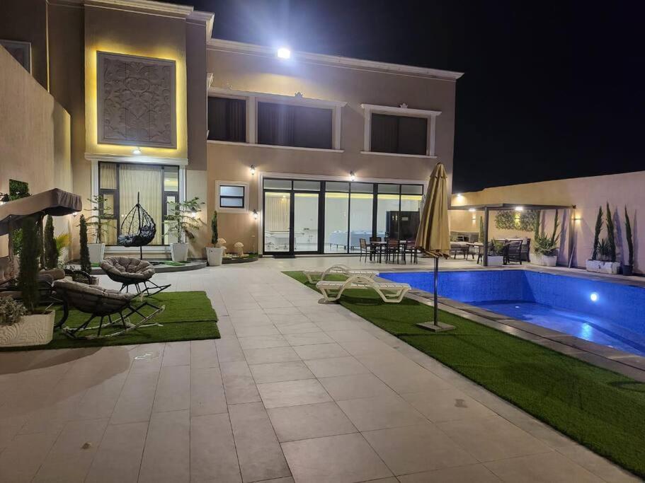 a house with a swimming pool in the yard at La Seema sea view chalet in Madaba