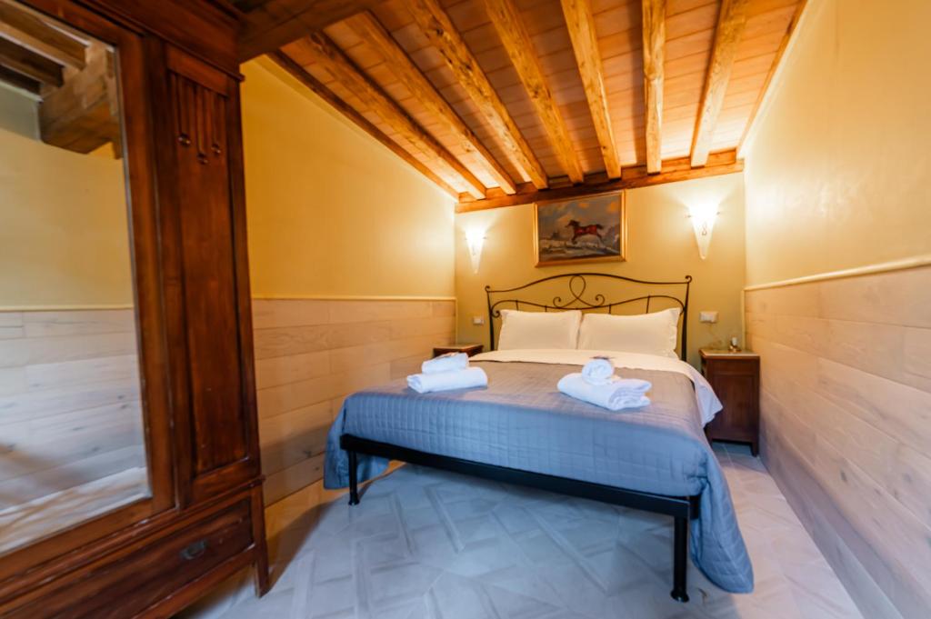 a bedroom with a bed with two towels on it at Luxury House in Green Appia Antica in Rome