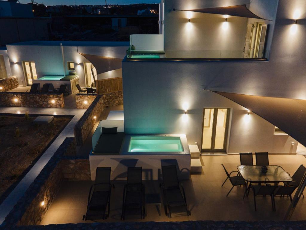 a view of a house with a swimming pool at night at Windmillside Luxury Villas in Emporio
