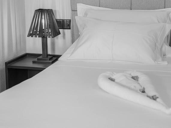 Postel nebo postele na pokoji v ubytování Nikara Beach Villas Arugambay