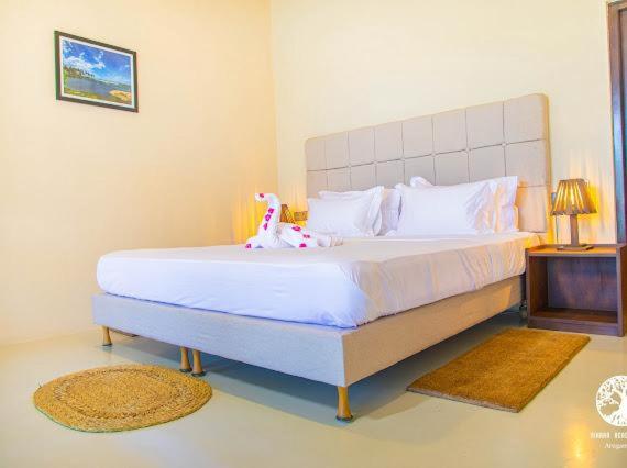 Postel nebo postele na pokoji v ubytování Nikara Beach Villas Arugambay