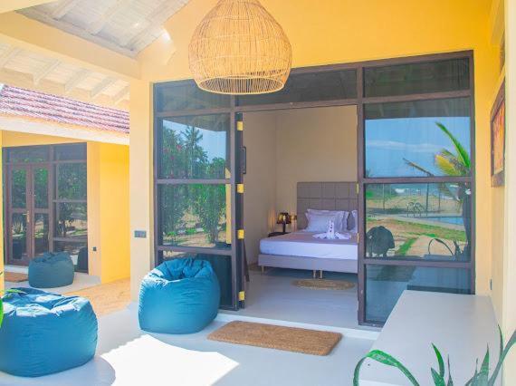 Postel nebo postele na pokoji v ubytování Nikara Beach Villas Arugambay