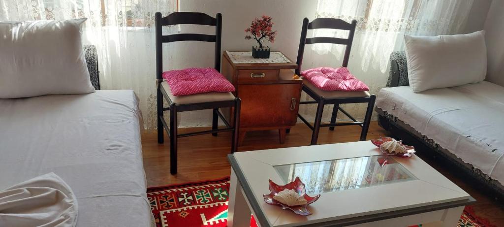 a living room with a couch and chairs and a table at Niku HomeStay in Berat