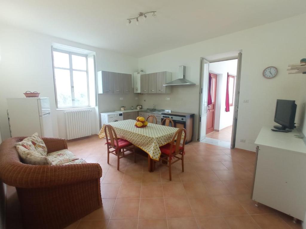 a kitchen and dining room with a table and chairs at Casa Scottodiuccio in Procida