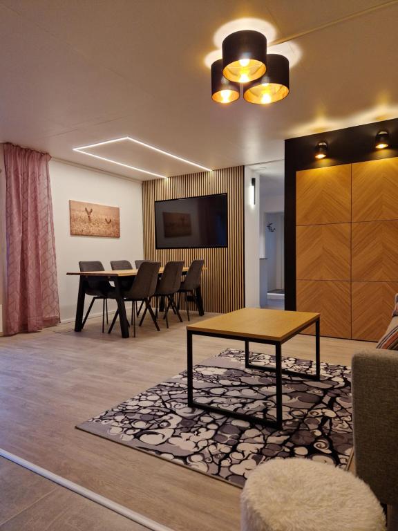 a living room with a table and a dining room at Villa Kataja in Siuntio