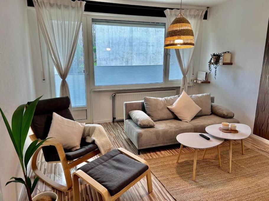 a living room with a couch and a table at Moderne ruhige Wohnung Bochum angebunden in Bochum
