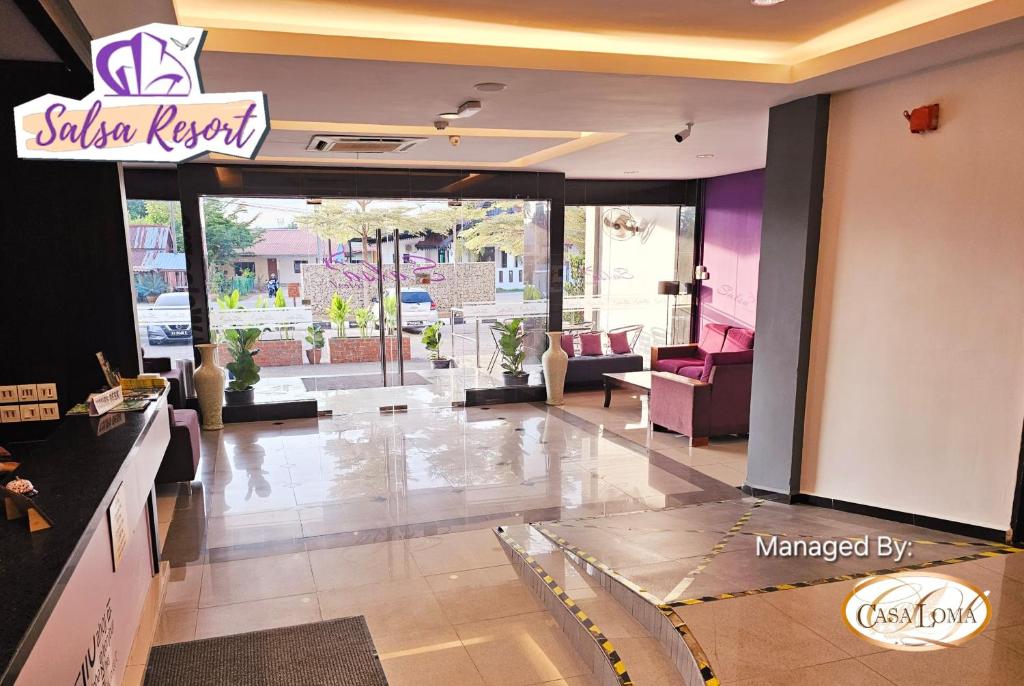 a lobby with a salon repair sign on the wall at Salsa Resort Langkawi By Casa Loma in Pantai Cenang