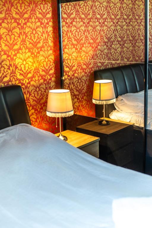 a bedroom with a bed and two lamps on tables at LARGE LUXURY APARTMENT WIELICZKA in Wieliczka