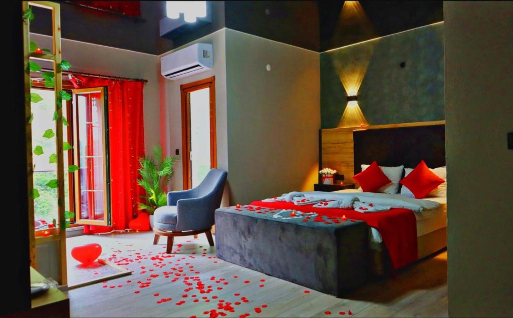 a bedroom with a bed with red flowers on the floor at Puğari Otel in Ardeşen