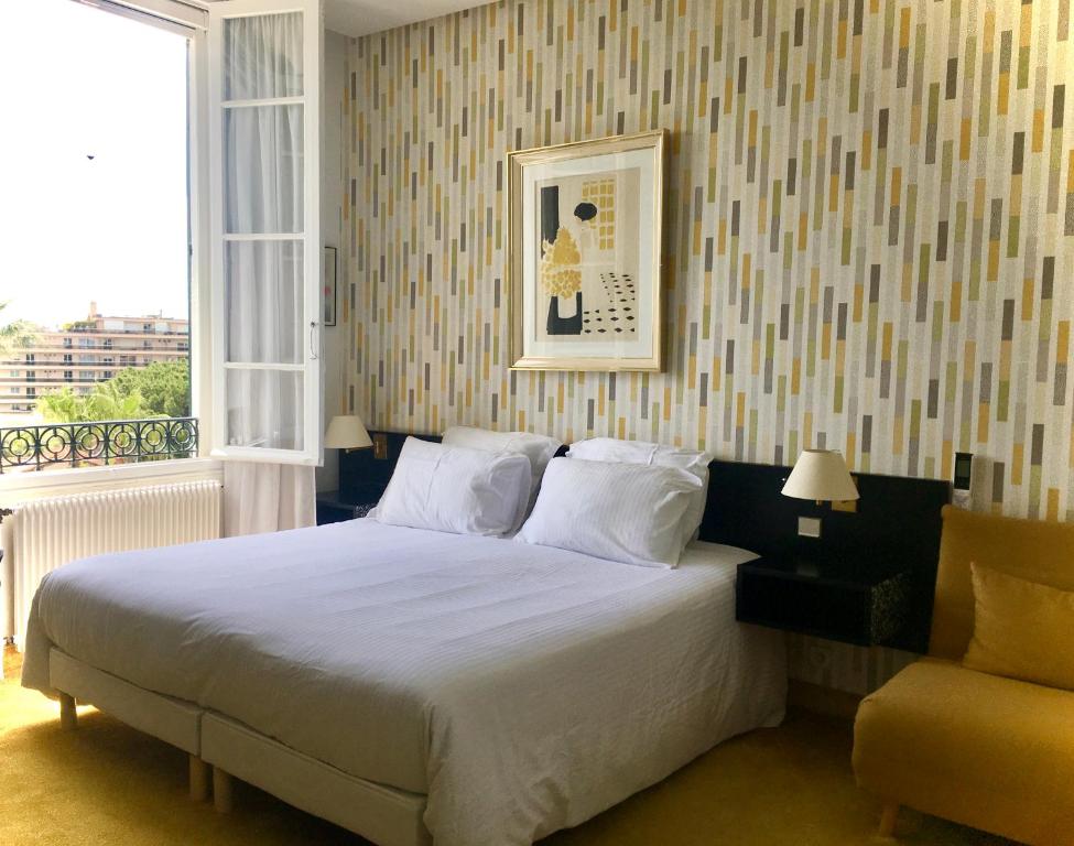 Postel nebo postele na pokoji v ubytování Hotel des Mimosas