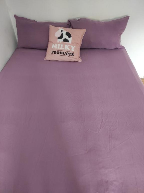 a purple bed with a pillow with a soccer ball on it at Begogane in Santurce