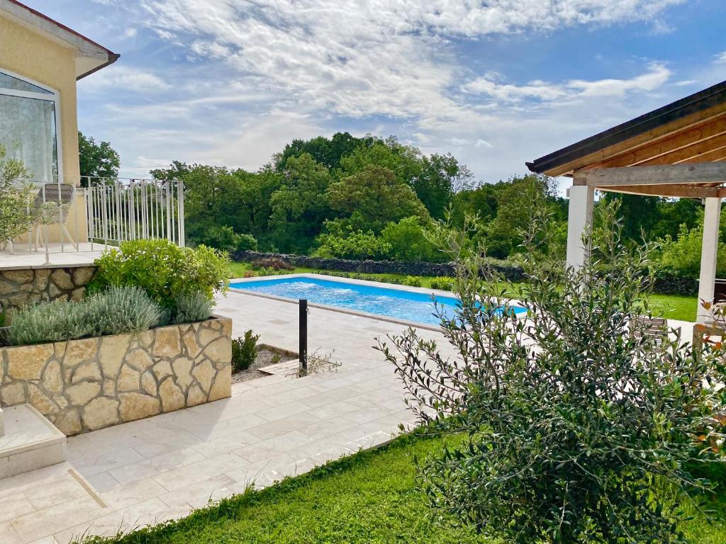 a swimming pool in the backyard of a home at Villa Yucca Istra in Labin