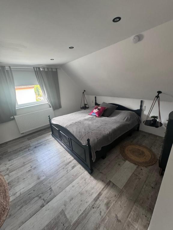 a bedroom with a bed and a wooden floor at Casa Di Monaco in Glees