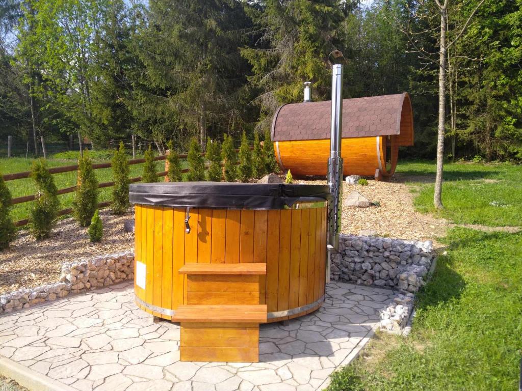 a large wooden trash can sitting on a patio at Chata na Zbojskej in Pohronská Polhora