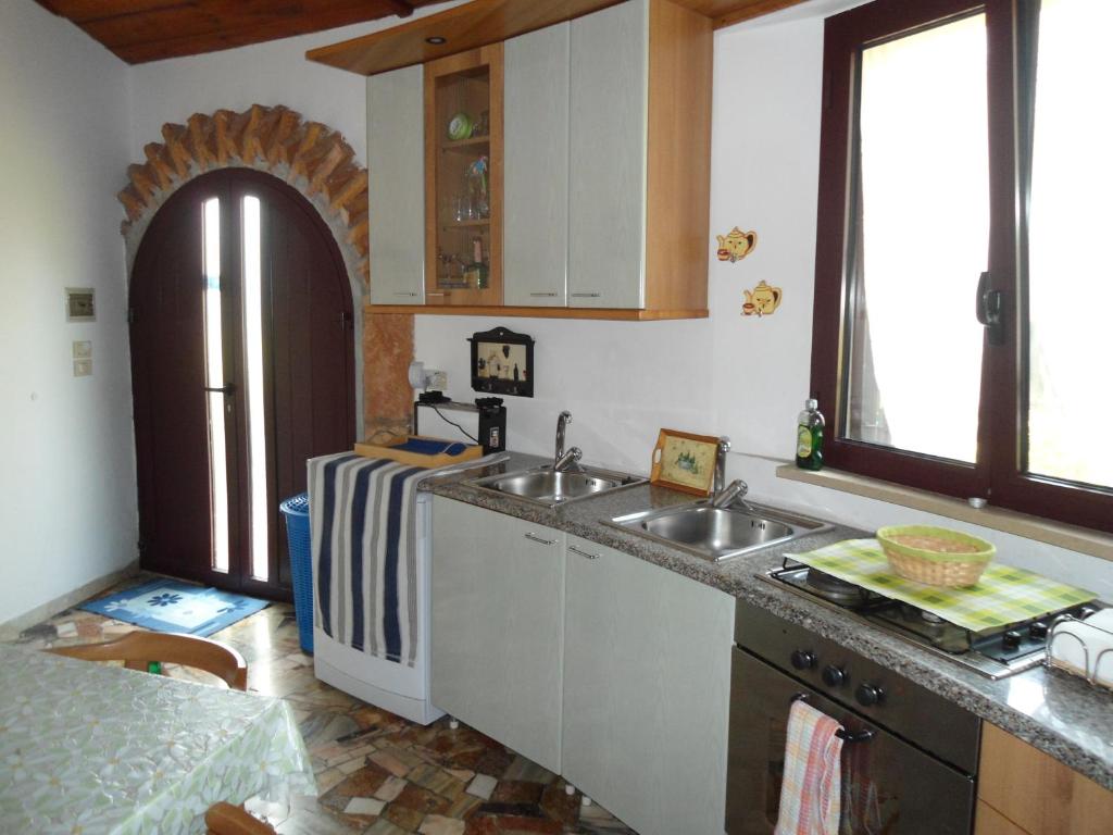 a kitchen with a sink and a counter top at Ville Alba & Azzurra in Polignano a Mare