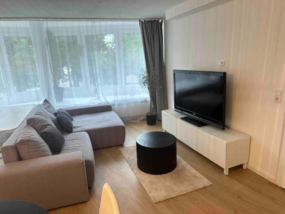 a living room with a couch and a flat screen tv at Appartement DUS in Düsseldorf