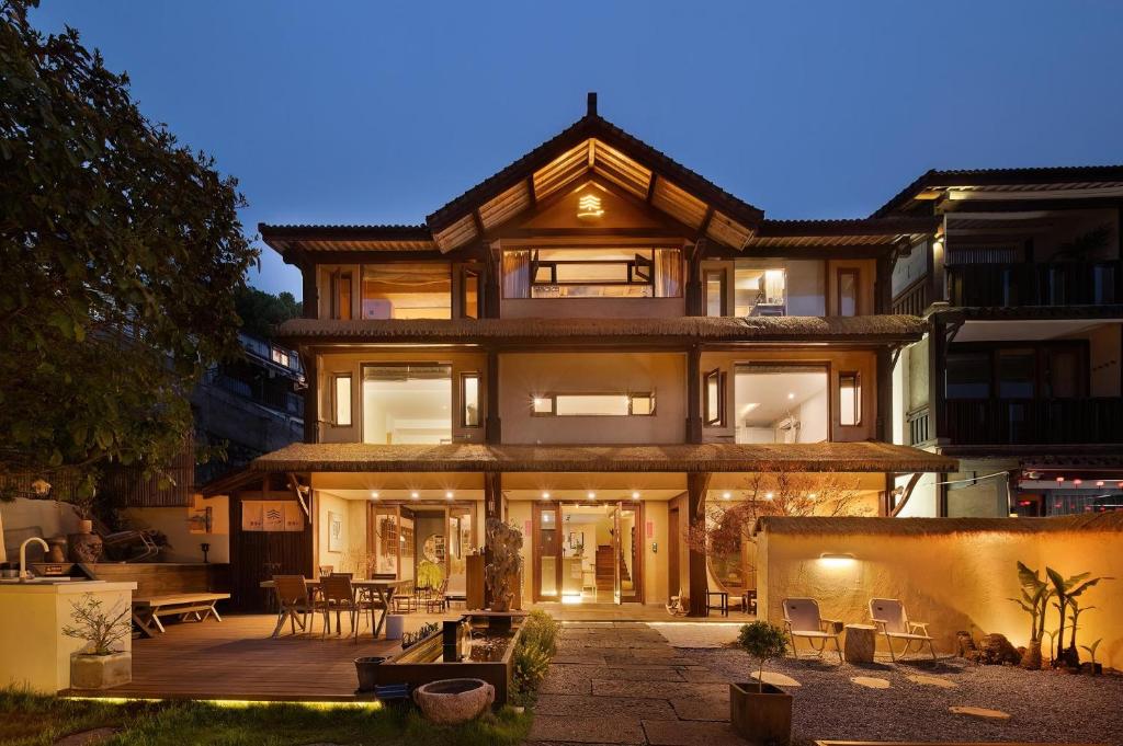 a large house with a patio in front of it at Xianqingshan Homestay in Hangzhou