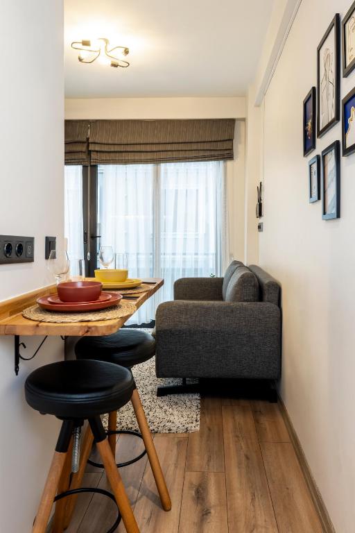 a living room with a table and a couch at Mariposa Rooms Taksim in Istanbul