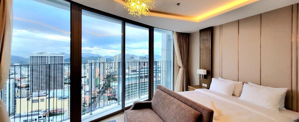 a hotel room with a bed and a large window at Panorama Apartment Sunset Nha Trang City in Nha Trang