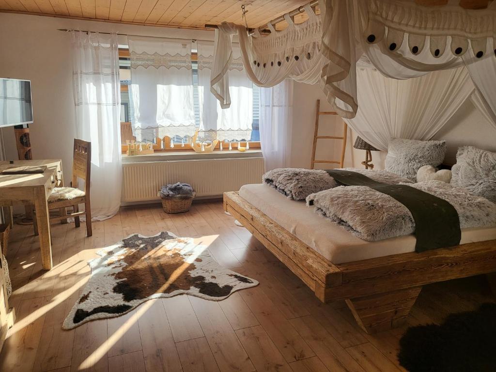 1 dormitorio con cama con dosel y piano en Ferienwohnungen Eisler, en Abensberg