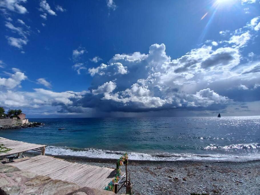 a view of the ocean with a wooden pier at Maison en bord de mer en Corse Lavasina Brando in Brando