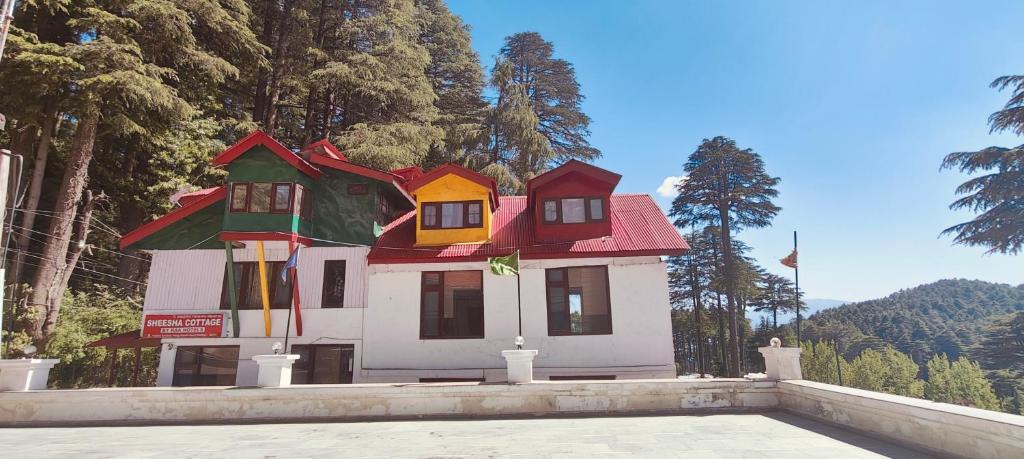 a house shaped like a house on top of a building at Sheesha cottage in Patnitop