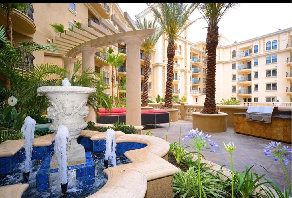 a fountain in the middle of a courtyard with a building at SoCal Lux on Bixel in Los Angeles