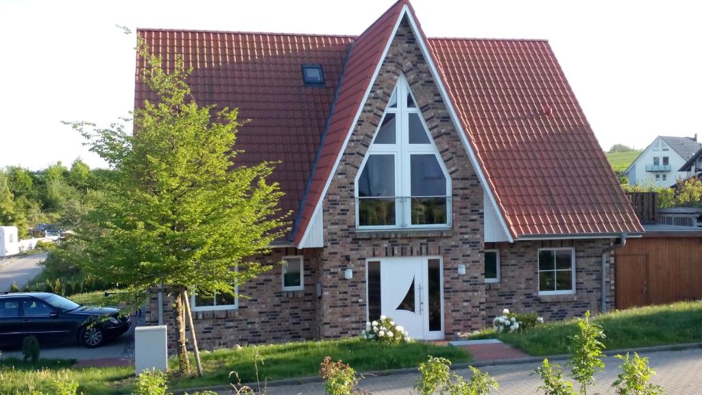 a small brick church with a triangular roof at Ferienhaus Mandy in Wohlenberg