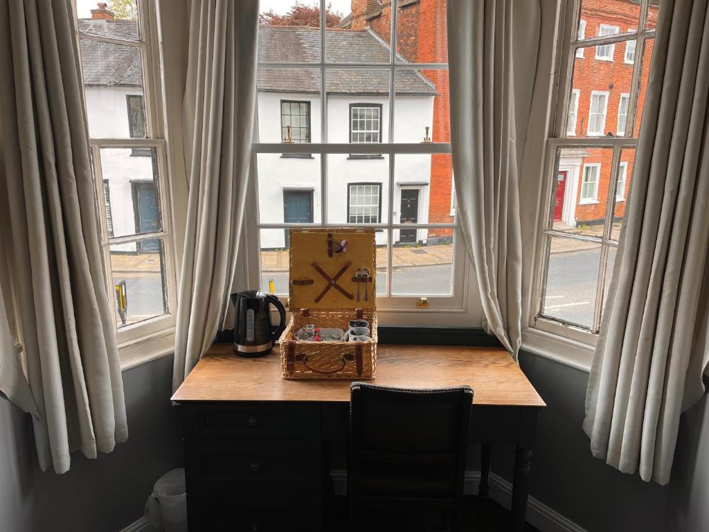 a box on a table in front of a window at The Olde Swan Hotel in Chertsey
