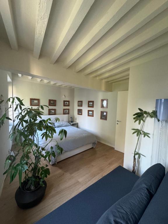 a large bedroom with a bed and a couch at Beautiful Center Apartments - posti auto privati prenotabili in Parma