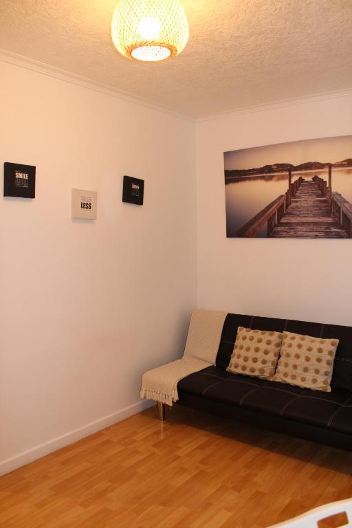 a living room with a couch and a picture of a pier at Madrid Fabulous Chamberí in Madrid