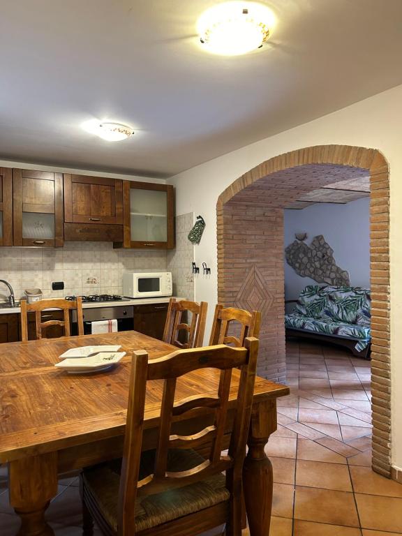 a kitchen and dining room with a wooden table at MAJELLA Pacentro in Pacentro