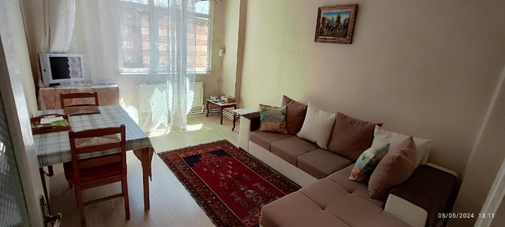 a living room with a couch and a table at Nur home1 Abuzer Yegin in Istanbul