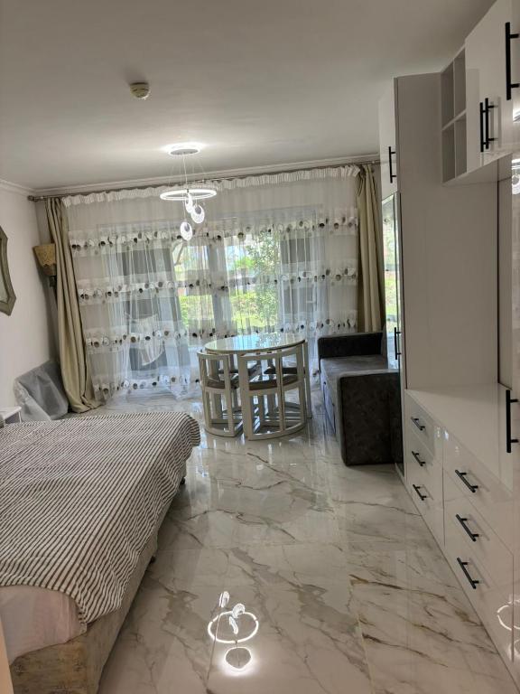 a room with a bed and a table and a chair at Domina Coral Bey Harem in Sharm El Sheikh