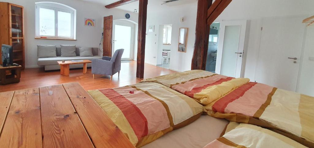 a large bed in a room with a living room at Sinsheim Ferienwohnung in Sinsheim