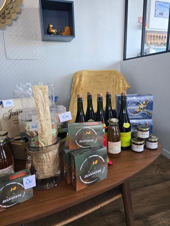 a table with a bunch of bottles of beer on it at Hôtel L'ideal le Mountbatten in Arromanches-les-Bains