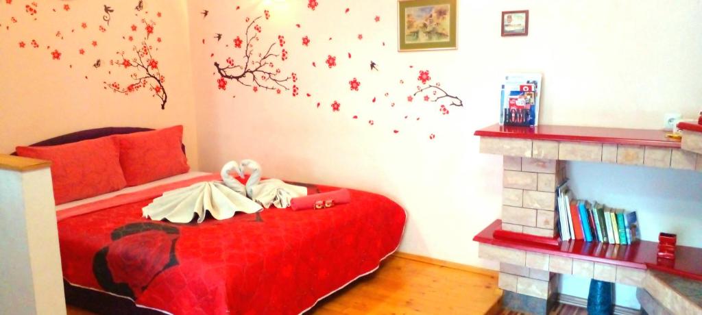 a bedroom with a red bed and a fireplace at 2A Apartments Bascarsija in Sarajevo