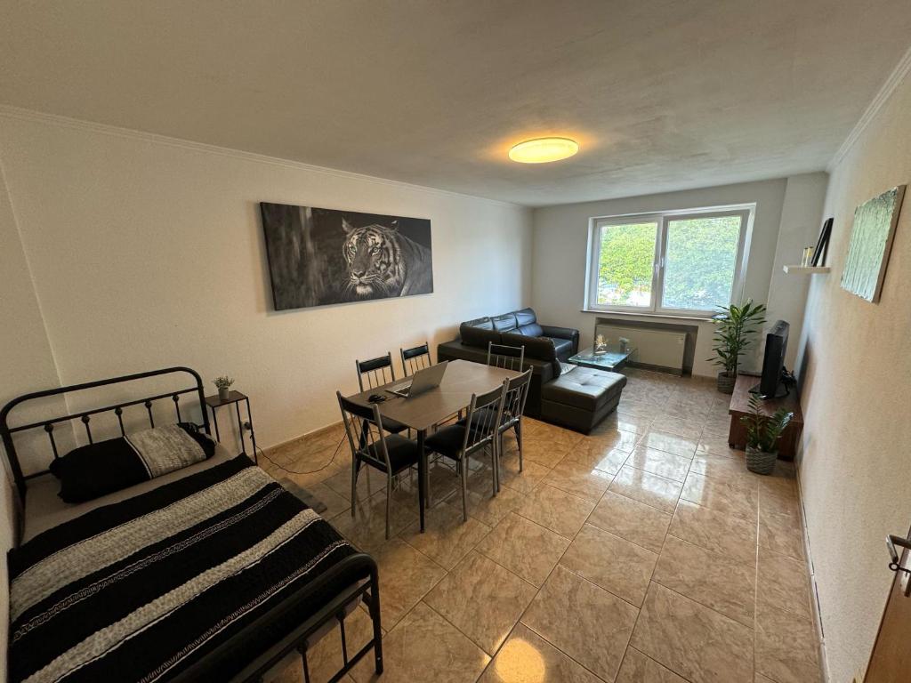 a living room with a bed and a table at Monteur Home in Solingen