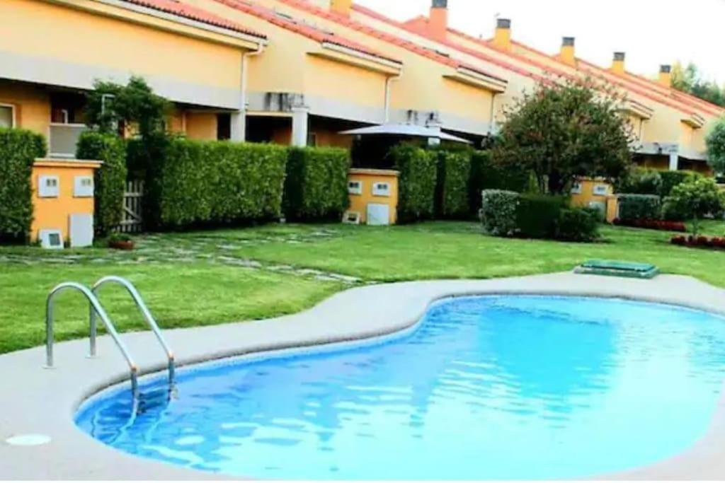 une grande piscine en face d'un bâtiment dans l'établissement PORTOSIN Apartamento con piscina, playa, à Goyanes