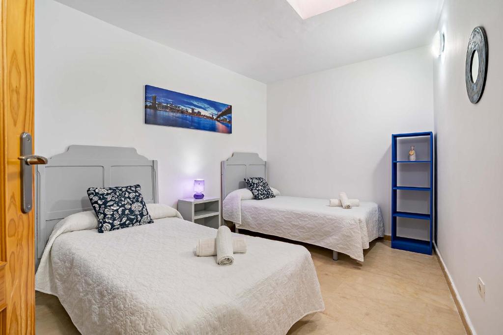 a small room with two beds and a couch at Apartamentos Dulcemar Frente al Mar con zona SPA in San José