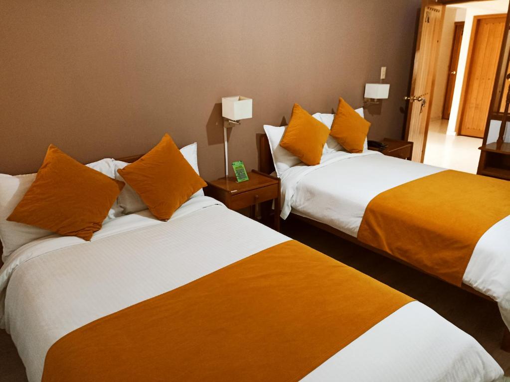 Postel nebo postele na pokoji v ubytování Hotel Tuvalu