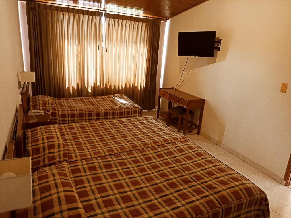 Postel nebo postele na pokoji v ubytování Hotel Tuvalu