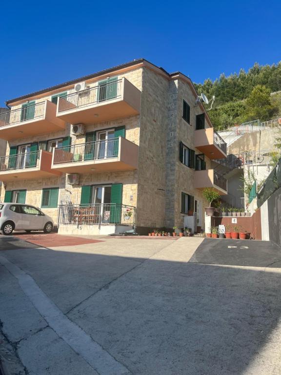a building with a car parked in front of it at Villa Borzic in Omiš