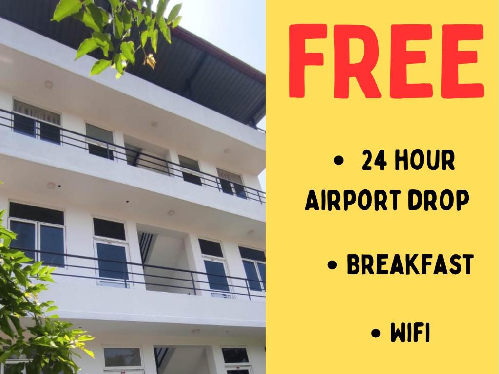 a sign that reads free hour airport dropbreakfast and a building at Marian Villa in Katunayake