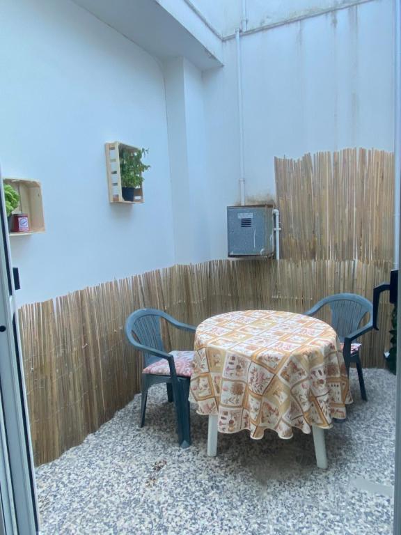 a table with two chairs and a table with a table cloth at Home 22 in Brindisi